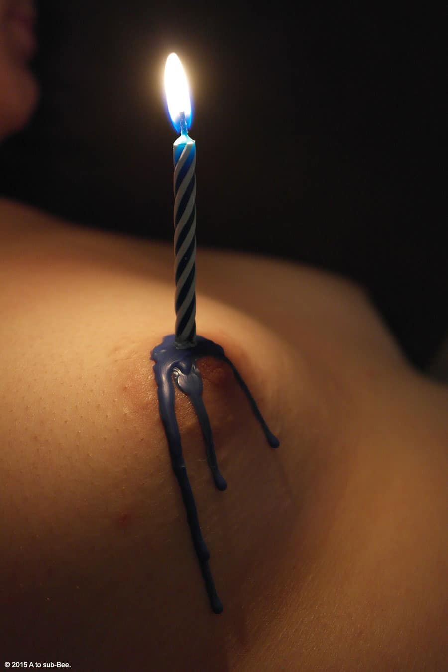 Sending congratulations for a 200th anniversary by showing a lit birthday candle on my Bee's breast.
