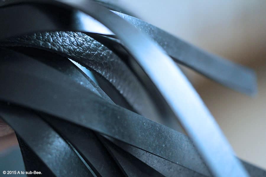 A macro shot of our new toy, a black leather and latex flogger