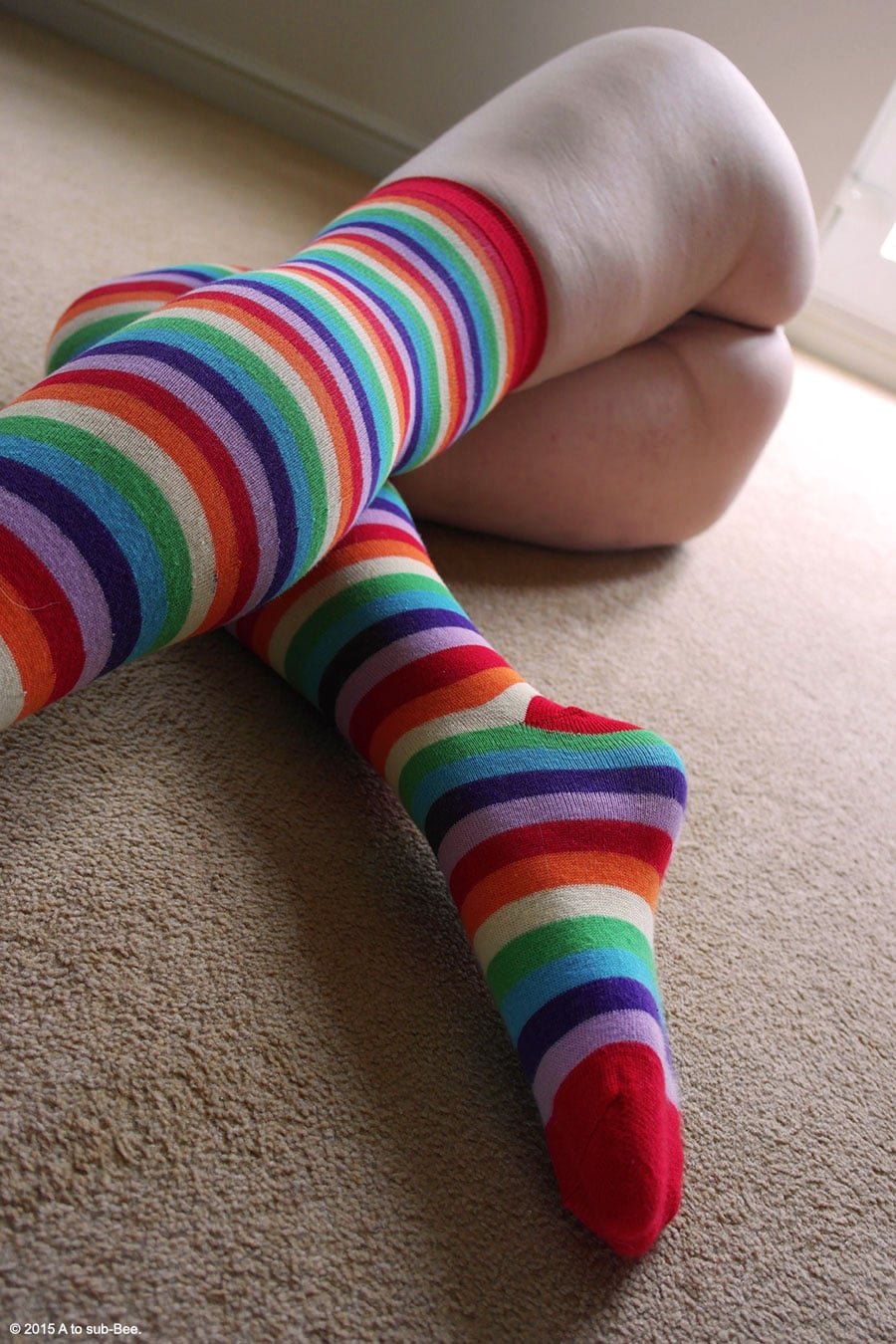 Bee wearing striped rainbow over the knee socks saying thank you to Molly for all her encouragement