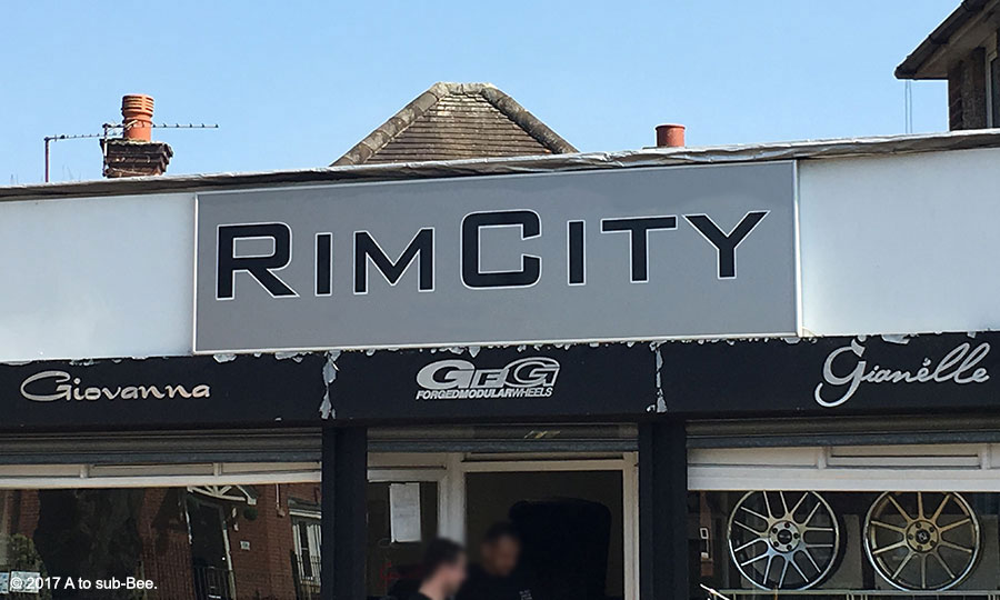 A Tongue In Cheek image of a tyre shop called rim city as a play on words for analingus