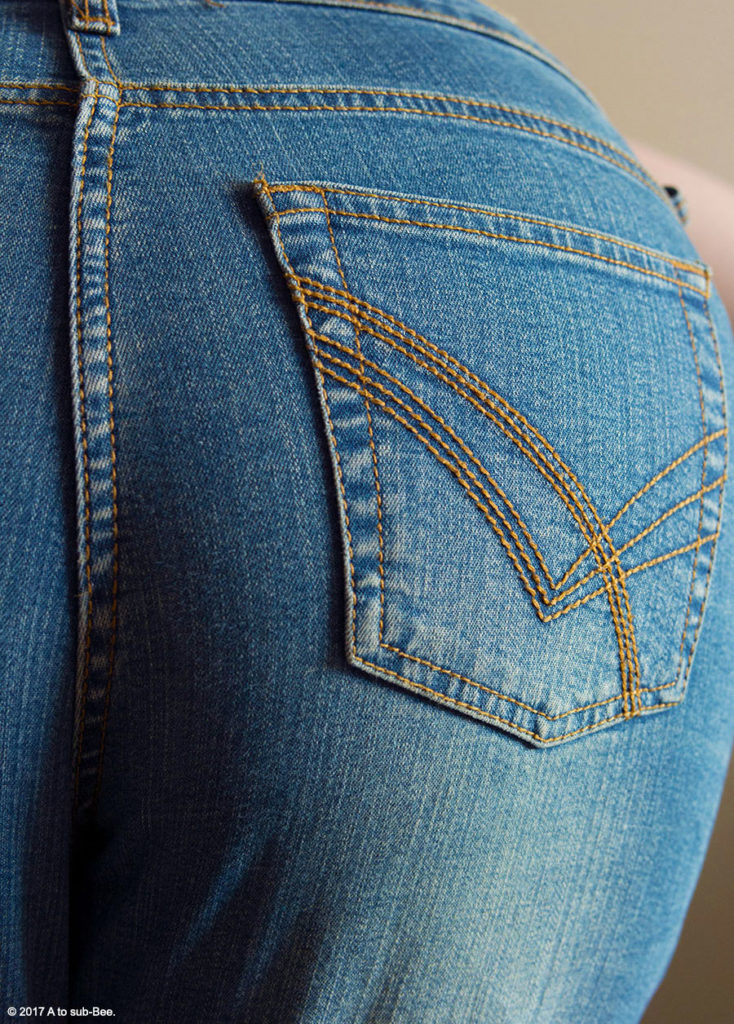 Bee's bottom in a pair of tight blue jeans
