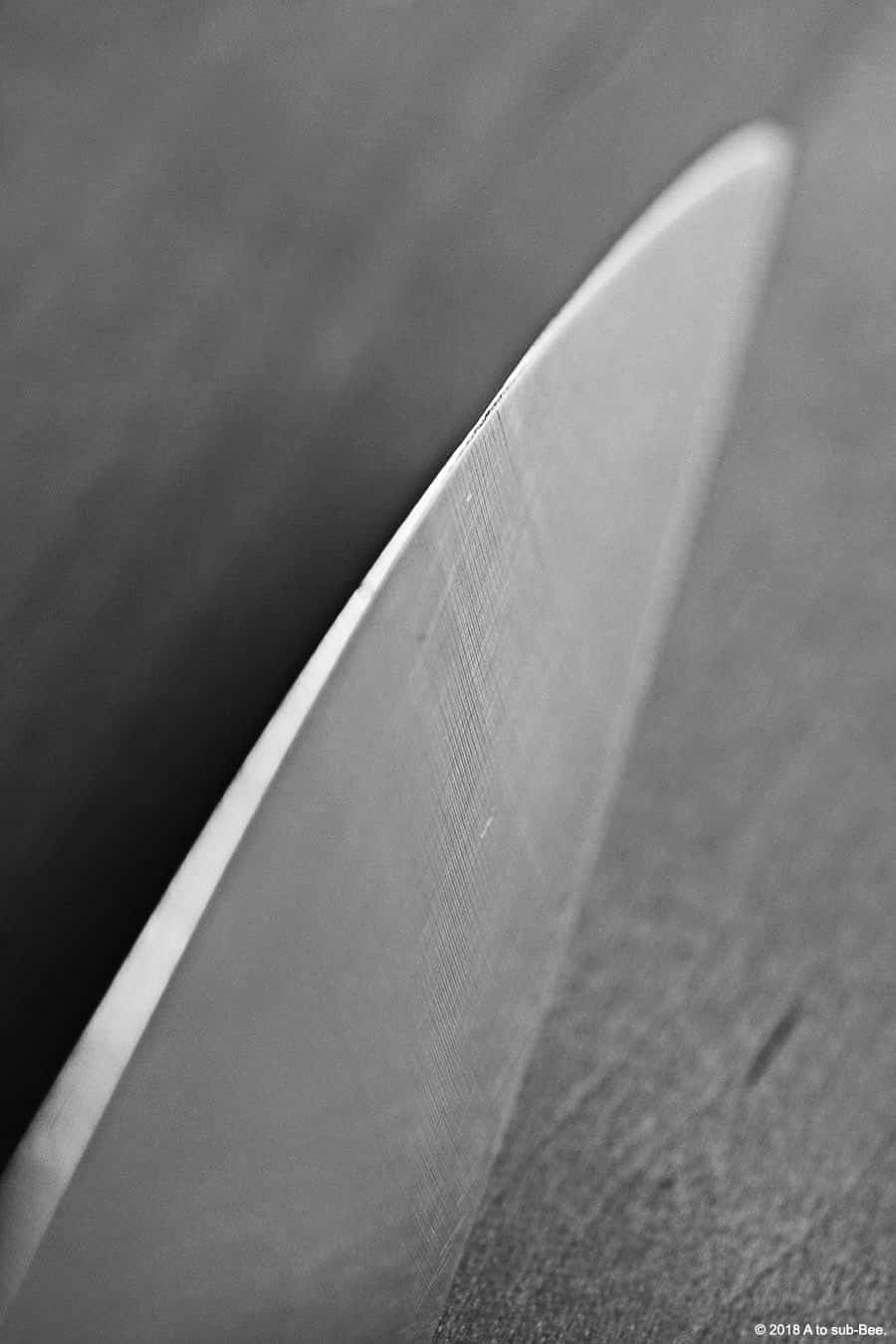 A menacing close up image of the edge of a knife