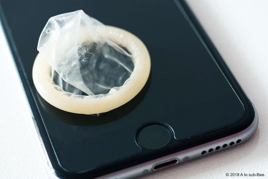 Condom sitting on a mobile phone