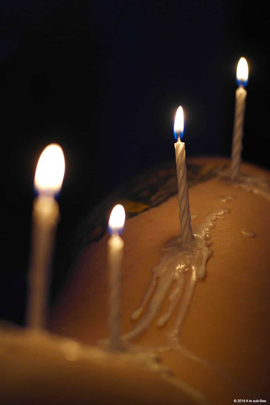 A row of candles melting on Bee's side