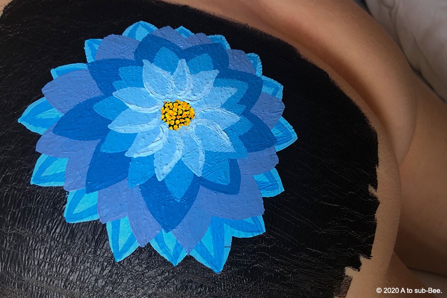 A blue dahlia painted on Bee's bottom completes another task